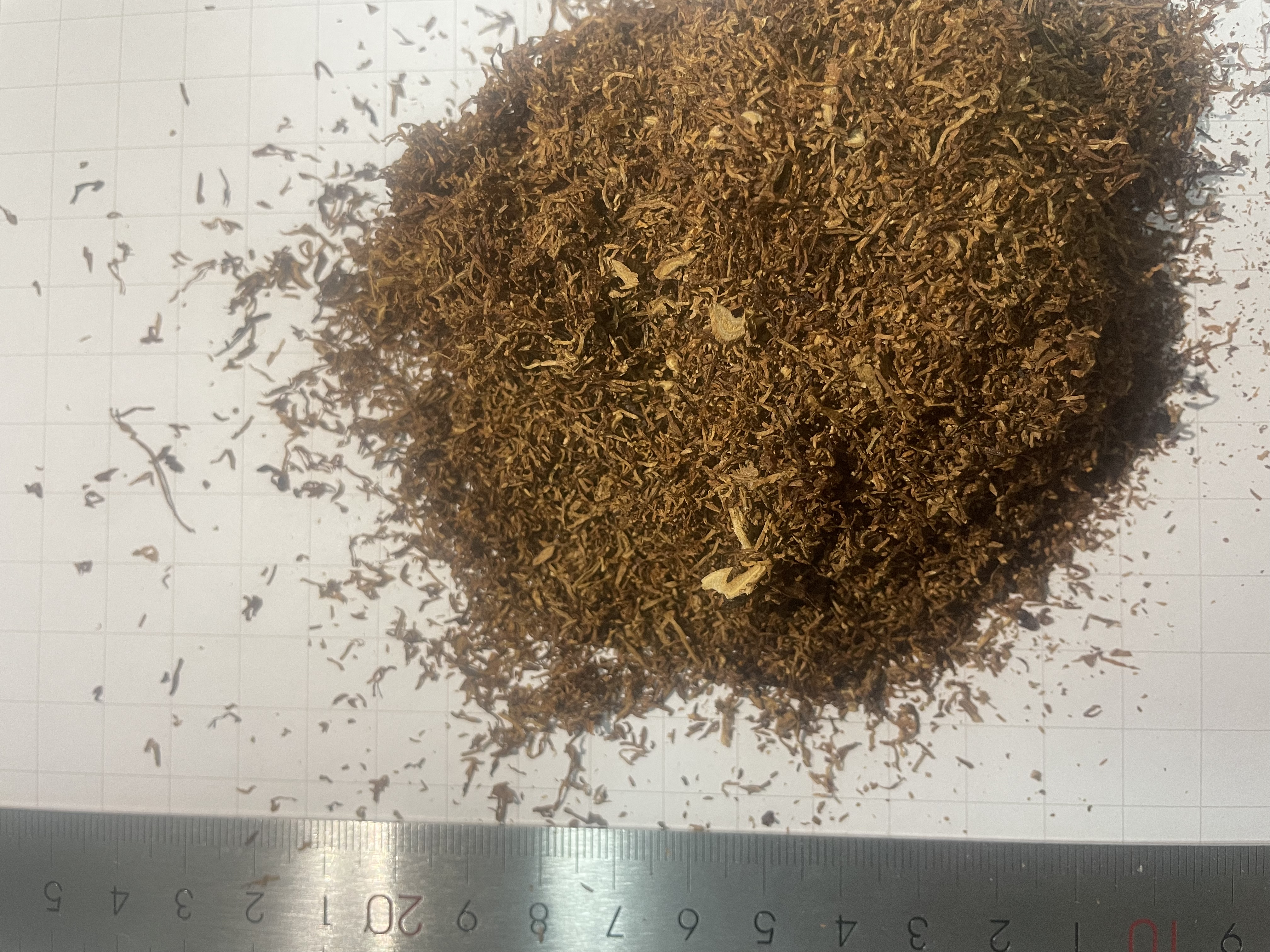 Tobacco sample photographed beside a ruler